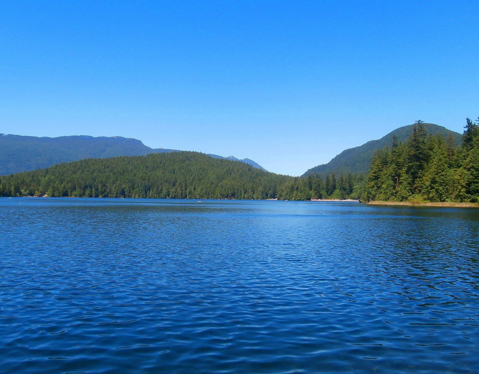 Buntzen Lake surrounded by forested mountains near Port Moody